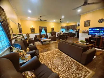 a large living room with couches and a tv at Homestay Desa Kati Kuala Kangsar in Kuala Kangsar