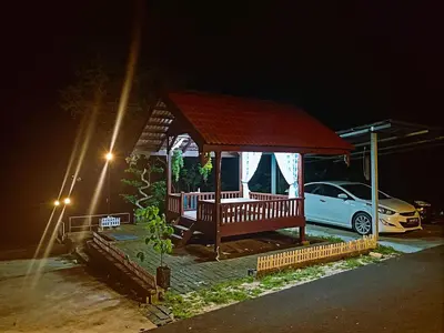 a gazebo in a parking lot at night at Homestay Desa Kati Kuala Kangsar in Kuala Kangsar