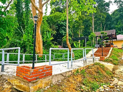 a street light sitting next to a brick wall at Homestay Desa Kati Kuala Kangsar in Kuala Kangsar