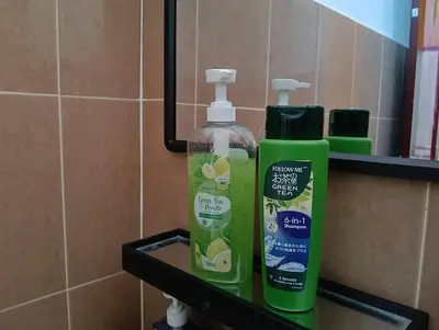 a bottle of mouth wash and a bottle of soap on a shelf at Luxurious Noble Homestay in Sungai Petani