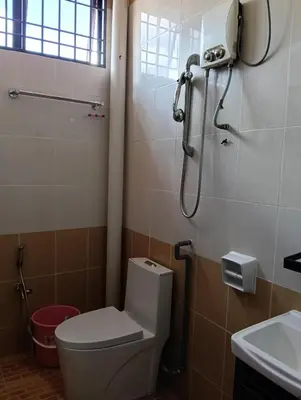 a bathroom with a toilet and a shower at Luxurious Noble Homestay in Sungai Petani