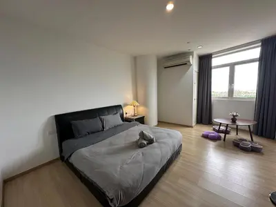 a bedroom with a bed with a cat laying on it at Joyful Seaview Studio 118 Island88 for 3pax in George Town
