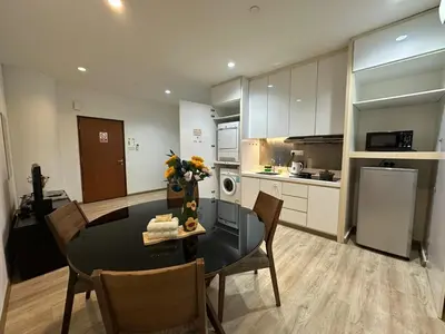 a kitchen and dining room with a table and chairs at Joyful Seaview Studio 118 Island88 for 3pax in George Town