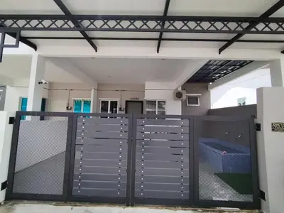 a garage with a gate and a basketball court at FDhomestay in Kampung Baharu Batu Dua
