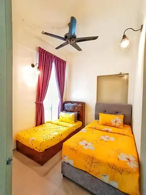 a bedroom with two beds and a ceiling fan at Cahaya homestay Penthouse Cameron Highlands in Brinchang