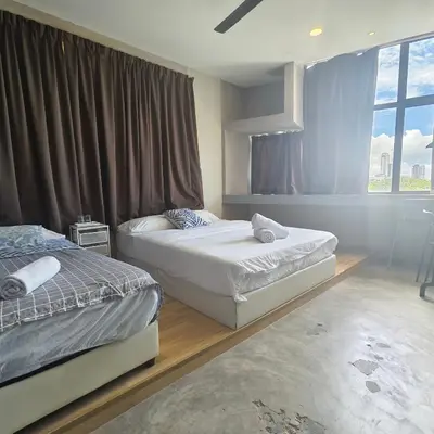 two twin beds in a room with a window at Wayton Cottage in George Town