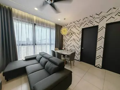 a living room with a black couch and a table at Penang Urban Homestay in Jelutong