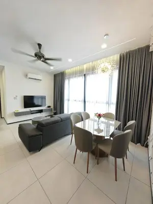 a living room with a couch and a table and chairs at Penang Urban Homestay in Jelutong