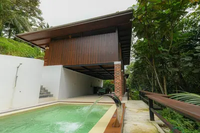 a house with a swimming pool and a bench at The HIJAU Camp & Cabin in Gopeng
