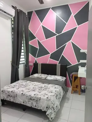 a bedroom with a bed and a geometric wall at D'Sawah Homestay in Kampong Gunong Semanggol
