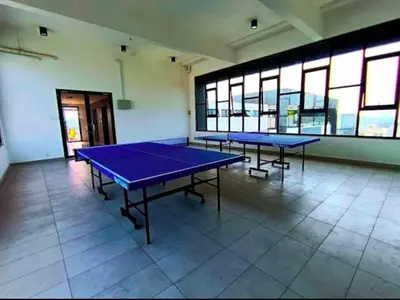 two blue ping pong tables in a room with windows at The Horizon - Ipoh' Rachel in Ipoh