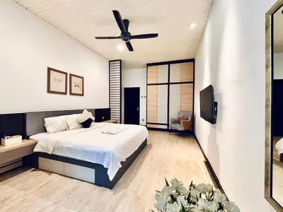 a bedroom with a bed and a ceiling fan at Regent Event & Leisure in Ipoh