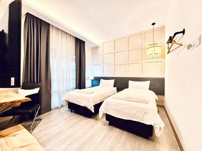 a hospital room with two beds and a window at Regent Event & Leisure in Ipoh