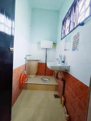 a bathroom with a toilet and a sink at D'Cozy Homestay in Seri Manjung