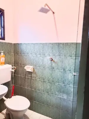 a bathroom with a shower and a toilet at D'Cozy Homestay in Seri Manjung