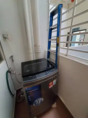 a machine sitting in a room with a window at Sekinchan Kent's House with wide paddy view in Sekincan