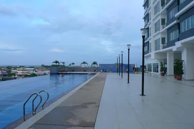 a swimming pool with lights next to a building at Sekinchan Kent's House with wide paddy view in Sekincan