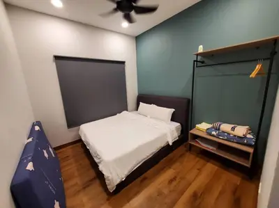 a small bedroom with a bed and a ceiling fan at Sekinchan Kent's House with wide paddy view in Sekincan