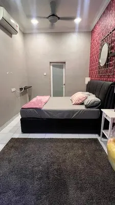 a bedroom with a bed and a couch and a mirror at Md Homestay in Kampong Kubang Menderong