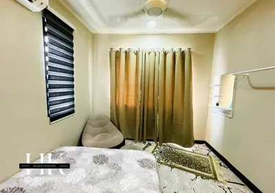 a small bedroom with a bed and a shower at Warisan Guest House Ipoh in Ipoh