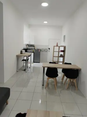 a kitchen with two tables and two chairs at Al Qarni Homestay in Ipoh