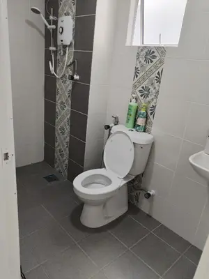 a bathroom with a toilet and a sink at Al Qarni Homestay in Ipoh
