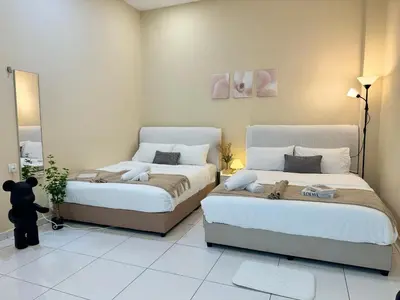 a bedroom with two beds and a mirror at Ipoh Lahat Mines Private Pool Lake Villa by IWH Suites in Lahat