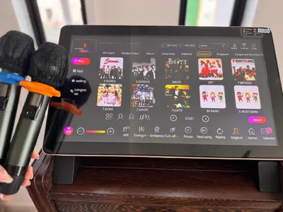 a tablet computer sitting on top of a wooden table at Ipoh Lahat Mines Private Pool Lake Villa by IWH Suites in Lahat