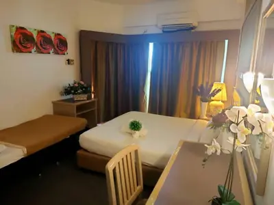 a small room with a bed and a table with a table sidx sidx at Seaview appointment 3 bedroom in Tanjung Bungah