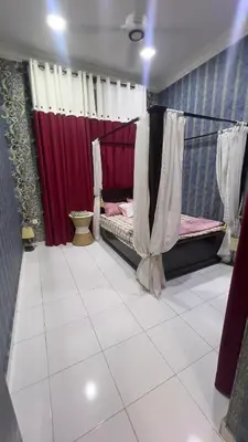 a room with two beds and red curtains at Md homestay in Kampong Kubang Menderong