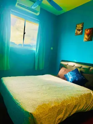 a blue bedroom with a bed and a window at charming 1br retreat in bayan lepas 1car park Malaysian guest only Netflix in Bayan Lepas