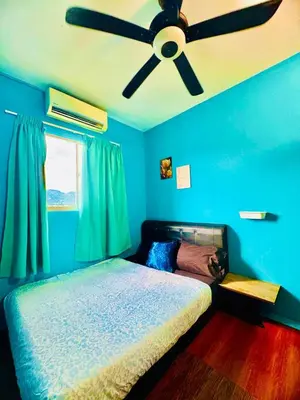 a blue bedroom with a ceiling fan and a bed at 2br bayan lepas 1car park Malaysian guest only in Bayan Lepas