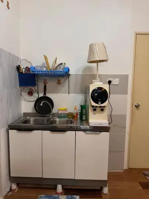 a kitchen counter with a sink and a microwave at 2br bayan lepas 1car park Malaysian guest only in Bayan Lepas