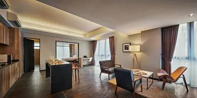 a living room with a table and chairs at Tropics Eight Suites in George Town