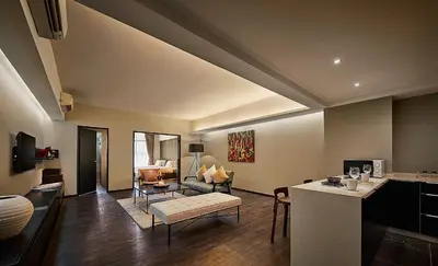 a living room with a couch and a table at Tropics Eight Suites in George Town