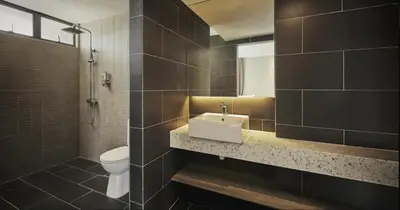 a bathroom with a sink and a toilet at Tropics Eight Suites in George Town