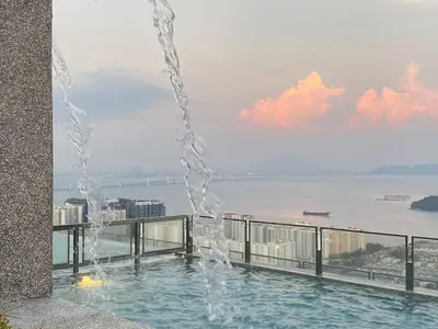 a swimming pool with a fountain on top of a building at Cozy 2BR Sky Pool & Panoramic Views 1-6 Guests in Bayan Lepas