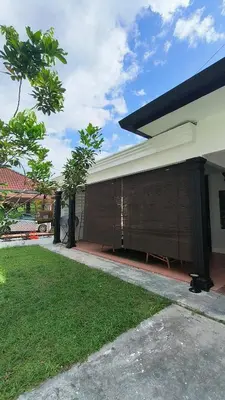a side view of a house with a building at Frangipine Villa in Tapah
