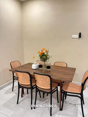 a dining room table with chairs and a vase of flowers at Senja Stay Homestay Kulim in Kulim