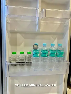 a refrigerator filled with lots of bottled mineral water at Senja Stay Homestay Kulim in Kulim