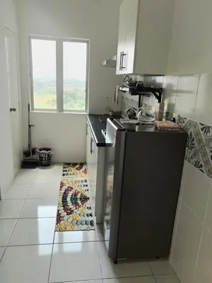 a kitchen with a sink and a counter top at Al Qarni Homestay 1 in Ipoh