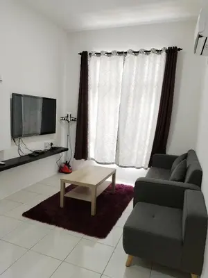 a living room with a couch and a coffee table at Al Qarni Homestay 1 in Ipoh