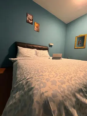 a bedroom with a bed with a laptop on it at 2pax 1car only Malaysian guest only bayan lepas in Bayan Lepas