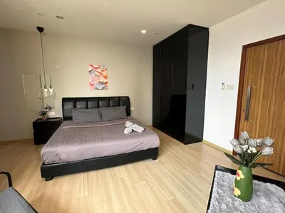 a bedroom with a bed and a vase of flowers at Comfort 1BR studio One One Eight Island Plaza in Tanjong Tokong