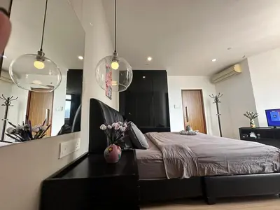a bedroom with a bed and a vase of flowers on a table at Comfort 1BR studio One One Eight Island Plaza in Tanjong Tokong