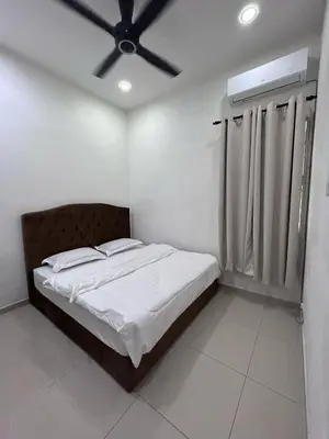 a bedroom with a bed with a ceiling fan at Naura Homes Penang in Kampong Batu Maung