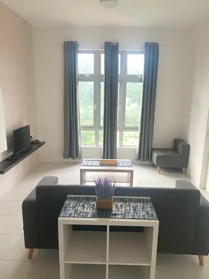 a living room with a couch and a table at Kyra's Downtown Delight in Ipoh