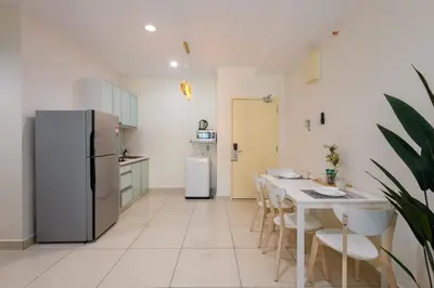 a kitchen with a refrigerator and a table with chairs at 2R2B Lovely Home 1-8pax Gurney Mansion One in George Town
