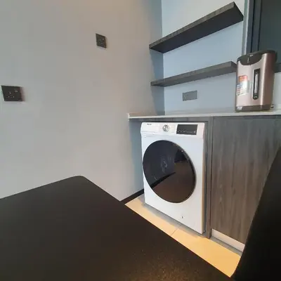 a washer and dryer in a kitchen with a counter at Urban Suites - Family Suite in Jelutong