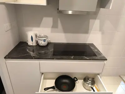 a kitchen counter with a frying pan on a stove at Venus Home Retreat - Pool,Gym,Playground,Rooftop Garden View in Kampong Lumut Kiri